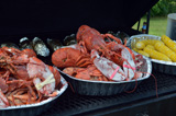 Lobster, corn, and baked potatoes ready to serve