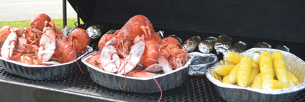 Cooked lobster and corn on the grill